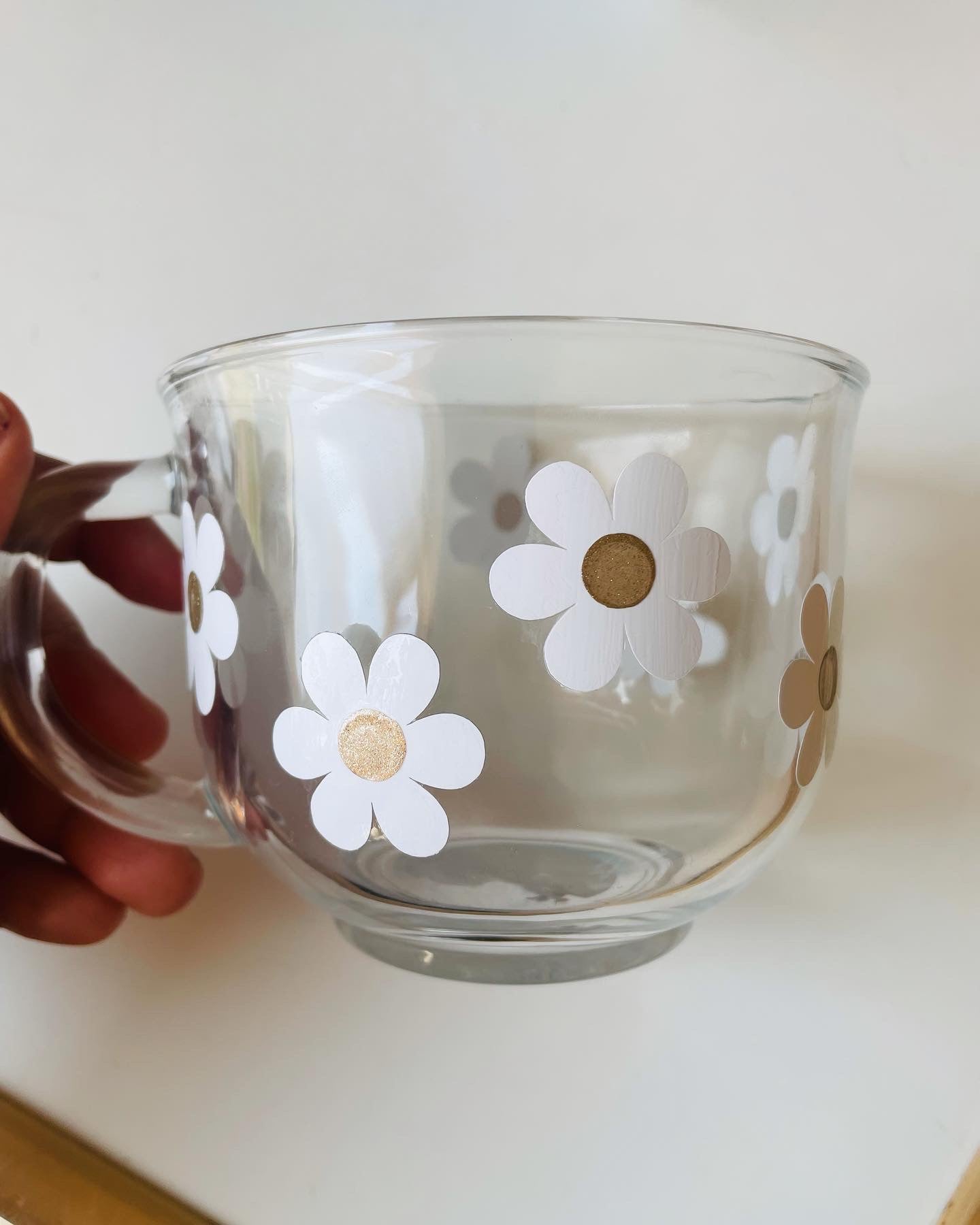 Glass cup with daisy flowers